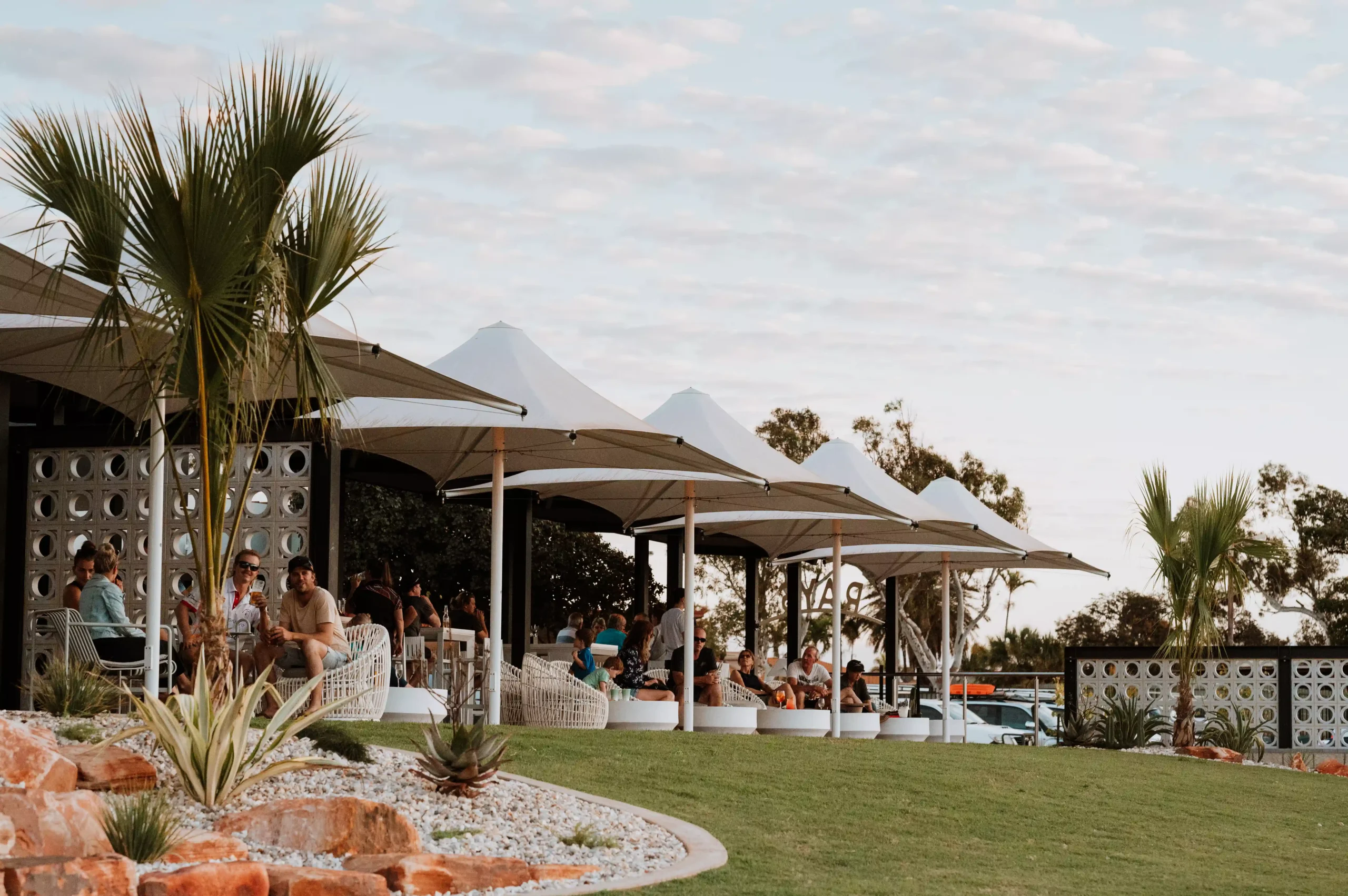 photo of the alfresco area at Rays during sunset, the venue is busy with people sitting around, talking and drinking