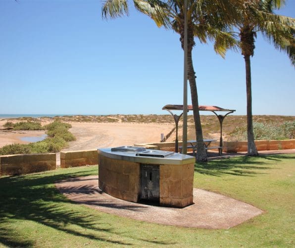 Photo of Pretty Pool Park in Port Hedland with a BBQ in the foreground and a beach in the background